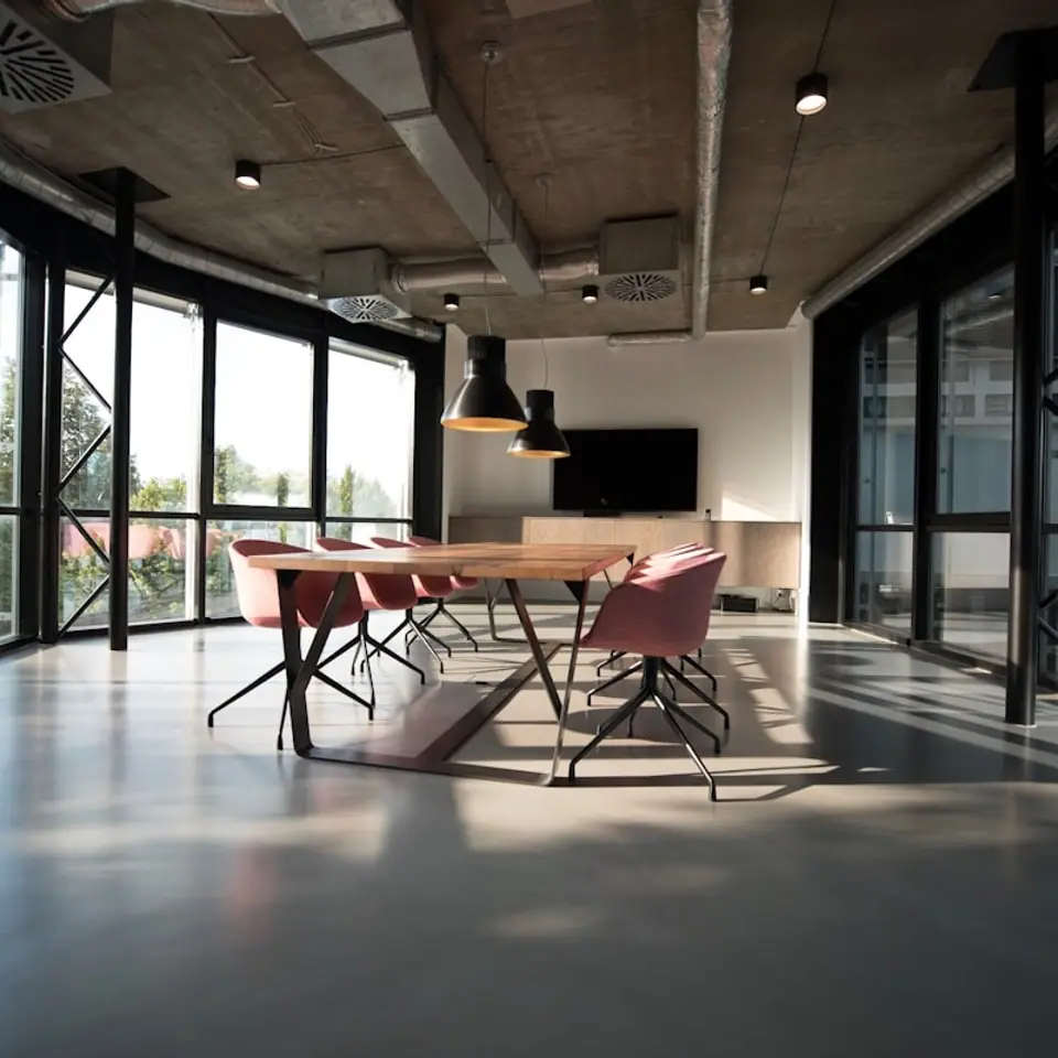 Modern workspace setup with desk, chairs, and natural light